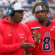 Jackson State football coach Deion Sanders, left, confers with quarterback Quincy Casey (8) during the second half of an NCAA college football game against Edward Waters in Jackson, Miss., Sunday, Feb. 21, 2021.